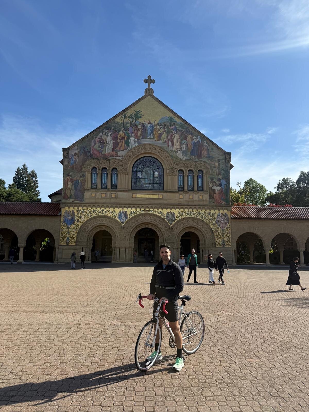 Dr. Matar with his road bike in front of Stanford Memorial Church