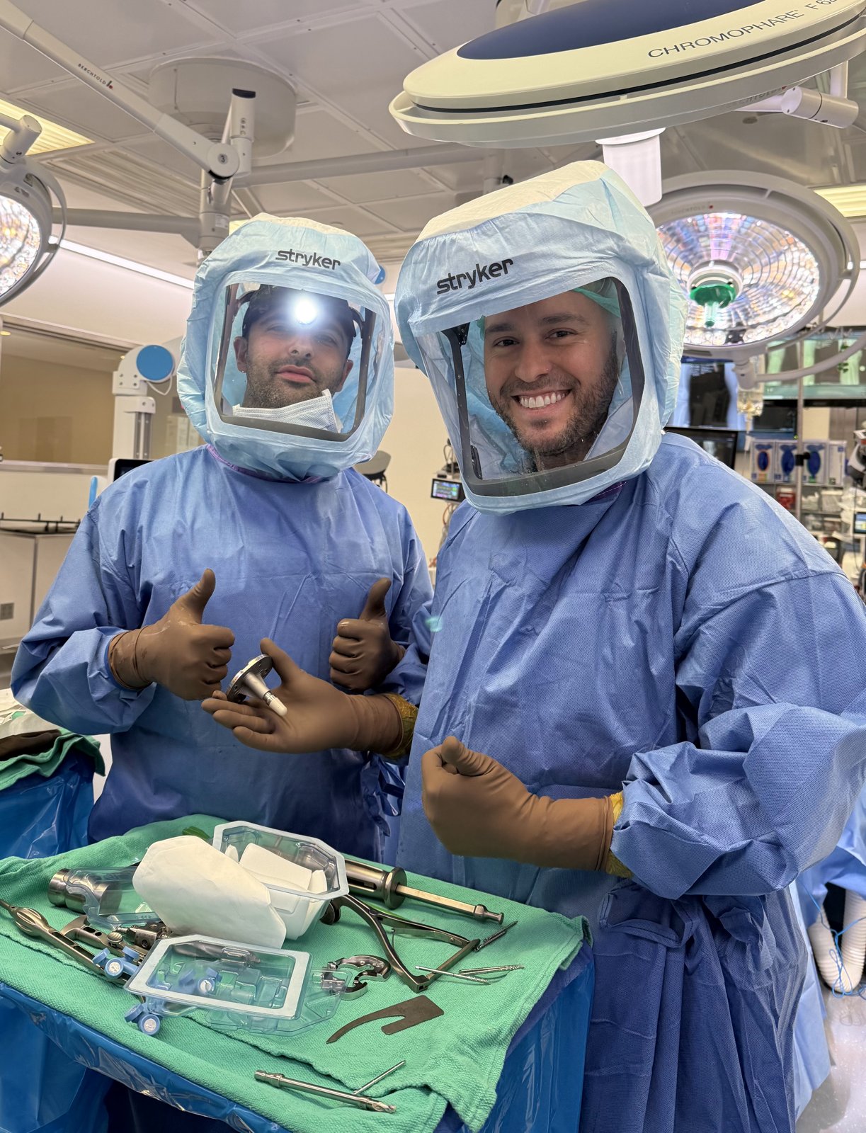 Dr. Matar and a colleague in surgical hoods in the operating room